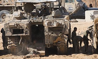 Israelische Soldaten arbeiten an ihren Panzern an einem Sammelpunkt an der Grenze zum Gazastreifen im Süden Israels, nachdem Israel und die Hamas eine Pause in ihrem Krieg und die Freilassung der verbleibenden Geiseln vereinbart haben. - Ariel Schalit/AP/dpa