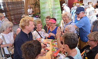 Umgeben von Fans gibt der Star-Florist Björn Kroner (links) Autogramme und Tipps. - Nicole Fischer