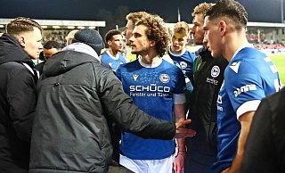 Im Anschluss an das 0:1 in Sandhausen stellen sich die Arminia-Profis Mael Corboz, Joel Grodowski und Stefano Russo (v. l.) den mitgereisten Fans. - IMAGO/Jan Huebner