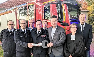 Löschgruppenführer Florian Sickmann (v. l. mit Schlüssel), Wehrleiter Andreas Rehermann und der Beigeordnete Michael Scholle übergeben das neue Fahrzeug für die Feuerwehr in Herste. Foto: Burkhard Battran - Burkhard Battran