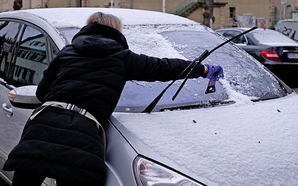 Eine Autofahrerin kratzt an einem frostigen Morgen die vereiste Windschutzscheibe ihres Fahrzeugs frei. - © picture alliance/dpa