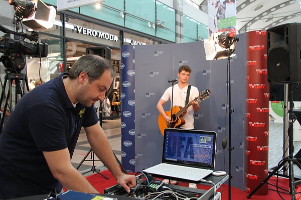 Ton ab: Marcel Nitschke (vorne) von der UFA-Talent-Base prüft, ob die Technik funktioniert. Der Vlothoer Songwriter Nico Terborg macht sich in der Zwischenzeit für seinen großen Auftritt beim Casting im Werre-Park bereit. - © Sonja Töbing