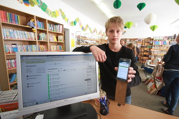 Noel (14) zeigt den neuen Online-Katalog, den er mit seinem Smartphone einsehen kann. - © FOTOS: MADITA PEINE