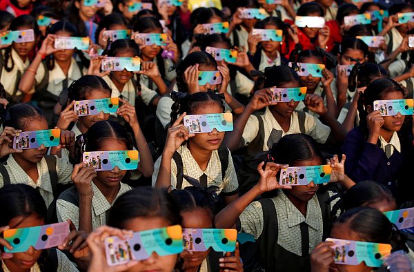 Kinder im indischen Ahmedabad betrachten die Sonnenfinsternis. - © REUTERS