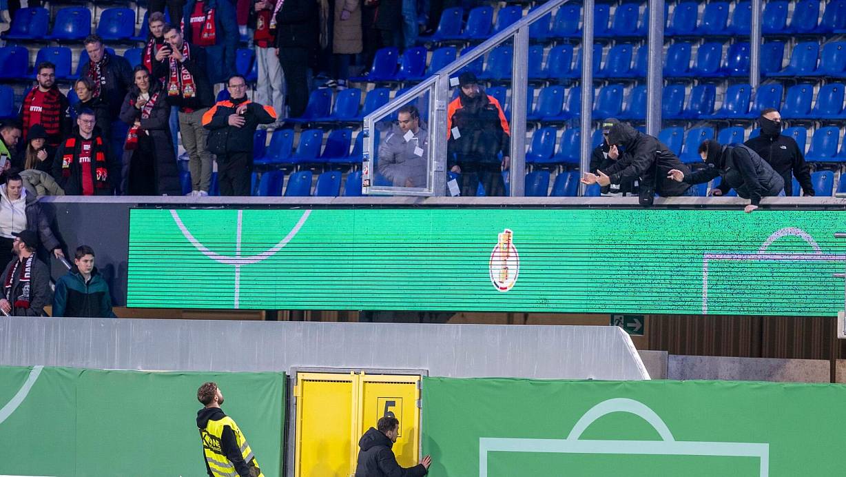Einige wenige Fans des SC Paderborn (r.) liefern sich an der Grenze zu den Gästeblöcken heftige Wortgefechte mit Leverkusener Anhängern, die im Innenraum von Ordnern zurückgehalten werden. Letzteres ist auf diesem Bild allerdings nicht zu sehen. | © dpa