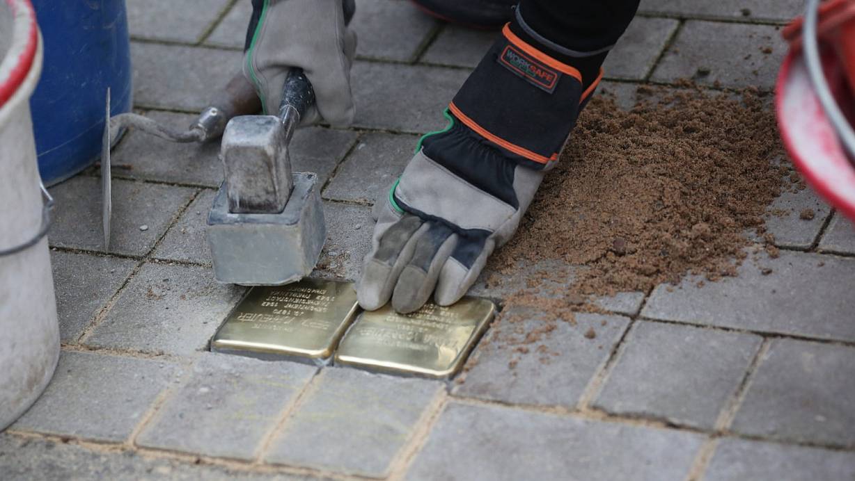 Künstler Gunter Demnig klopft in der Dr.-Neuhäußer-Strasse die beiden Stolpersteine fest, die an die Schwestern Emma und Berta Vorreuter erinnern sollen. | © Elke Niedringhaus-Haasper