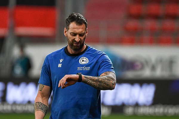 Arminia-Trainer Mitch Kniat blickt in Ingolstadt auf die Uhr. Mit Schiedsrichter Speckner war Kniat nicht zufrieden. - © IMAGO/Eibner