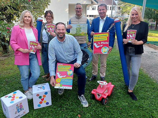 Die Jury verkündet den Sieger im Spielplatzwettbewerb: Fachberaterin Katharina Sinn (Kreis Höxter, v. l.), Julia Handtke und Heiko Böddeker von der GfW, Playparc Geschäftsführer Steffen Strasser, Landrat Michael Stickeln und Ehrenamtsmanagerin Katharina Serinelli (Kreis Höxter). - © Kreis Höxter