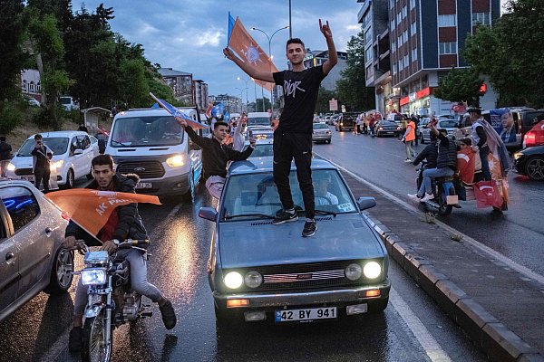 Anhänger des türkischen Präsidenten feiern in Autokorsos in der erdbebengeschädigten Stadt Kahramanmaras. - © AFP or licensors