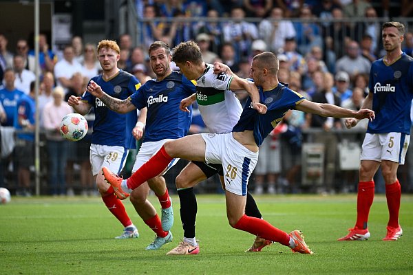 Holsteins David Zec (r) blockt den Ex-Kieler Benedikt Pichler im Trikot von Hannover 96. - © Gregor Fischer/dpa