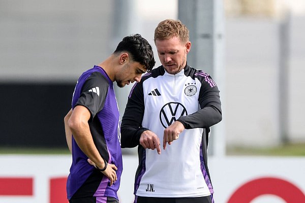 Bundestrainer Julian Nagelsmann (r) im Fachgespräch mit Aleksandar Pavlovic beim Training. - © Daniel Löb/dpa