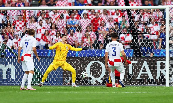 Kroatiens Torhüter Dominik Livakovic (2.v.l) kann das 0:3 durch Spaniens Dani Carvajal (hinten r, verdeckt) nicht verhindern. - © Andreas Gora/dpa