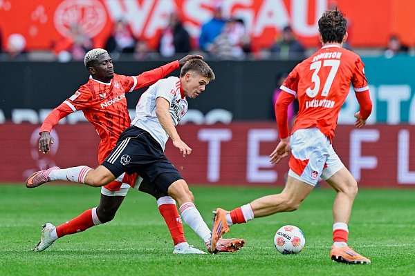 Nürnbergs Finn Becker (weißes Trikot) gegen Lauterer Abwehrbollwerk - © Uwe Anspach/dpa