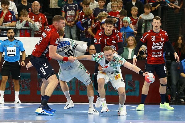 Omar Ingi Magnusson (SC Magdeburg, M) verliert im Zweikampf gegen Blaz Blagotinsek (SG Flensburg-Handewitt) und Marko Grgic (SG Flensburg-Handewitt) den Ball. - © Michael Hundt/dpa