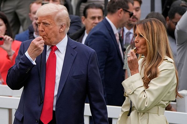 Präsident Donald Trump und Melania Trump blasen während des White House Easter Egg Roll in Trillerpfeifen. - © Alex Brandon/AP/dpa