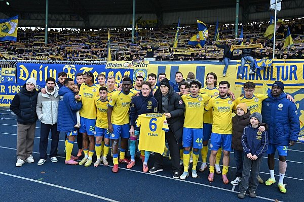 Jubel mit Flick-Trikot: Die Spieler von Eintracht Braunschweig grüßen nach dem 2:0-Sieg gegen Kaiserslautern ihren verletzten Mitspieler. - © Swen Pförtner/dpa