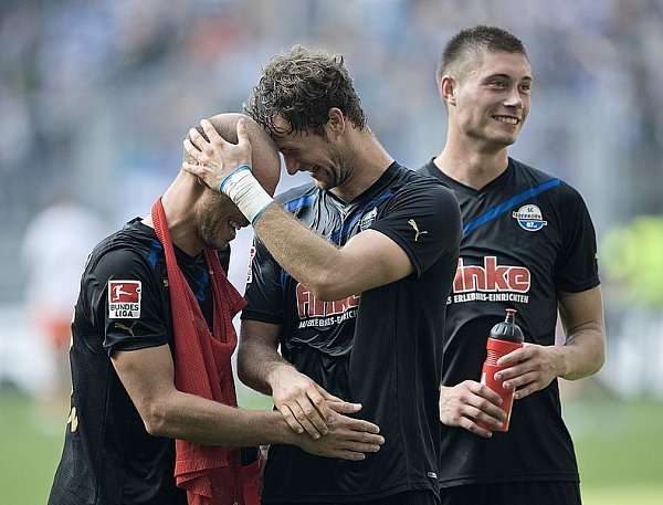 Paderborns Torschütze Nick Proschwitz (M), Daniel Brückner (l) und Christian Strohdieck freuen sich nach Spielende. - © FOTO: DPA