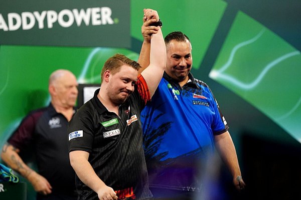 Dieses Bild gab es im Ally Pally selten: Martin Schindler (l) nach seinem Vorrundensieg bei der vergangenen WM. - © Zac Goodwin/PA Wire/dpa