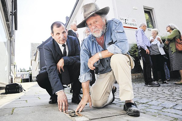 Erinnerungsstücke aus Messing: Künstler Gunter Demnig (r.) hat die ersten beiden Stolpersteine in Lichtenau selbst verlegt. Auch vor dem früheren Haus der Familie Buchdahl sind sie seit Dienstag zu finden. - © Jens Reddeker