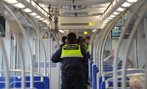 Ein Mitarbeiter eines Sicherheitsdienstes kontrolliert Fahrgäste in einer S-Bahn. - picture alliance/dpa